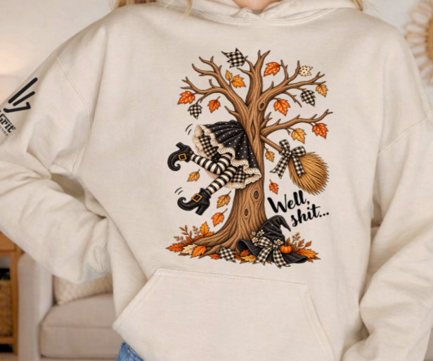 Funny witch hoodie featuring a witch who crashed her broom into a tree