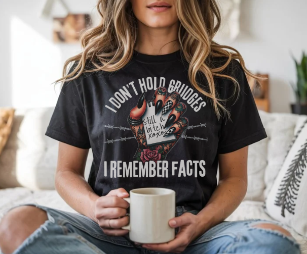 Sarcastic gothic graphic tee with hand holding note saying still a bitch