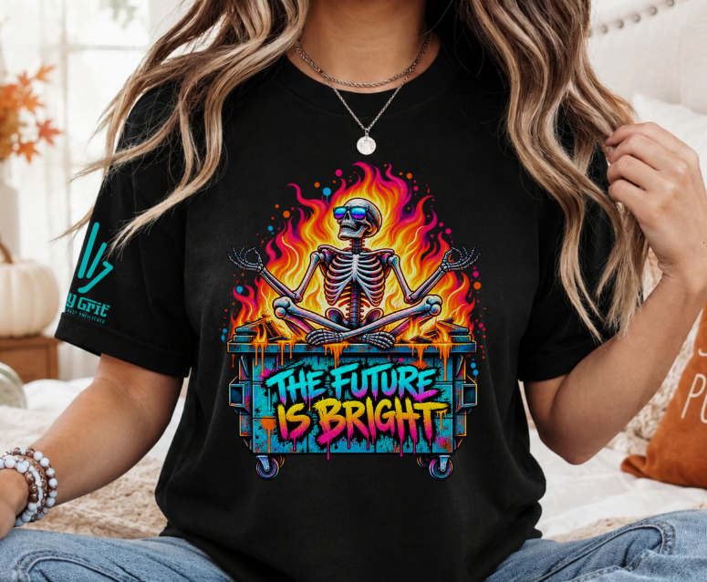 Dark-humor skeleton illustration sitting in a flaming dumpster beneath “The Future Is Bright” lettering.