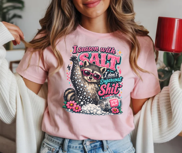 Funny shirt featuring I Season With Salt I Don't Sugarcoat Shit quote with raccoon throwing salt