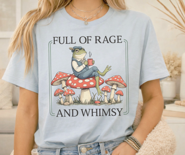 Sarcastic graphic tee featuring a grumpy frog on woodland mushrooms