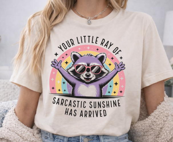 Funny shirt with your little ray of sarcastic sunshine has arrived quote and raccoon design